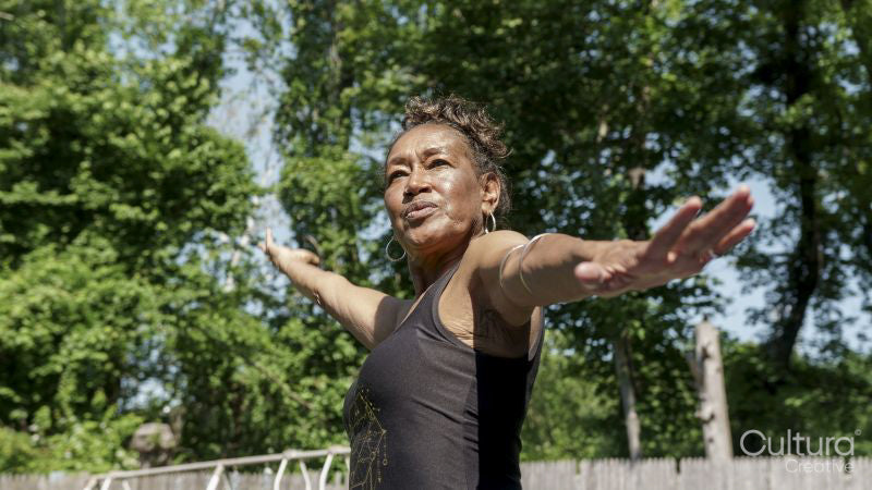 Senior woman doing yoga outdoors