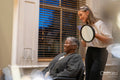 Smiling senior woman getting hair done in hair salon