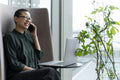 Non binary office worker resting in office lobby