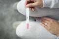 Woman checking pregnancy test, view from above