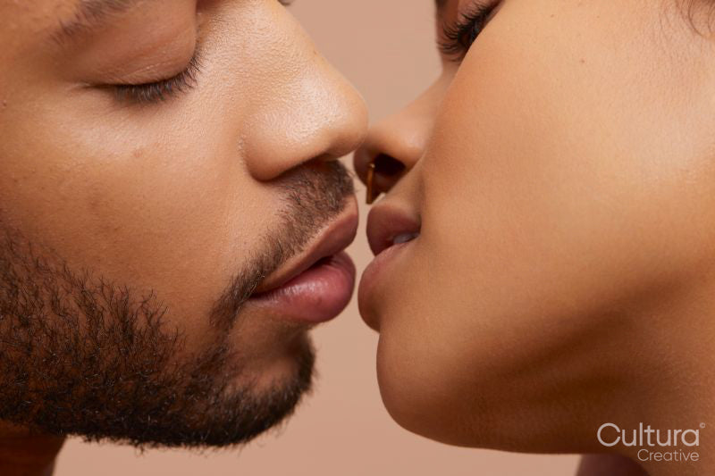 Studio portrait of kissing couple