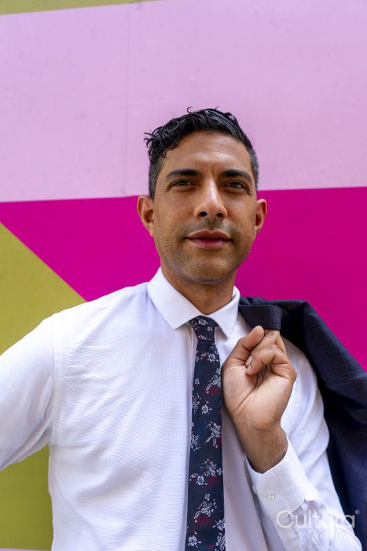 Businessman standing against colorful wall