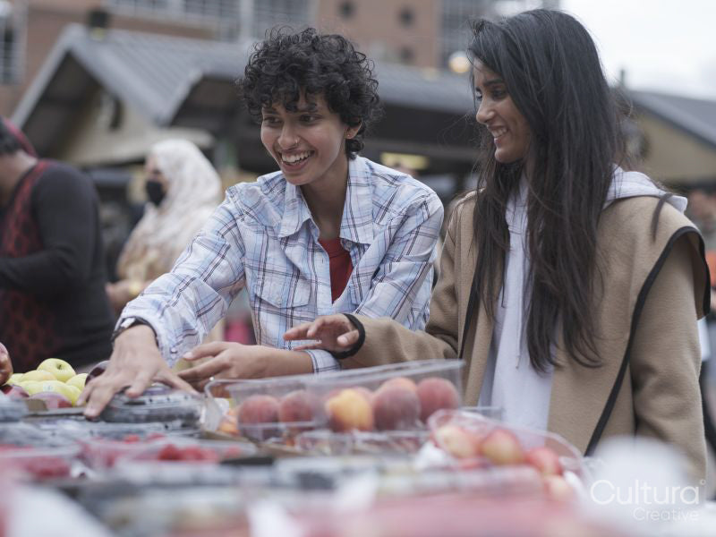 Female couple shopping in farmer''s market