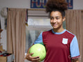 Smiling girl holding soccer ball