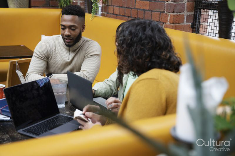 People using laptops in coworking space