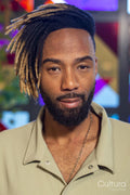 Portrait of man standing against colorful window