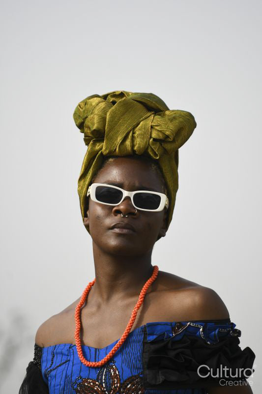 Portrait of young woman wearing headscarf and sunglasses