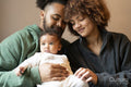 Parents sitting with baby daughter at home