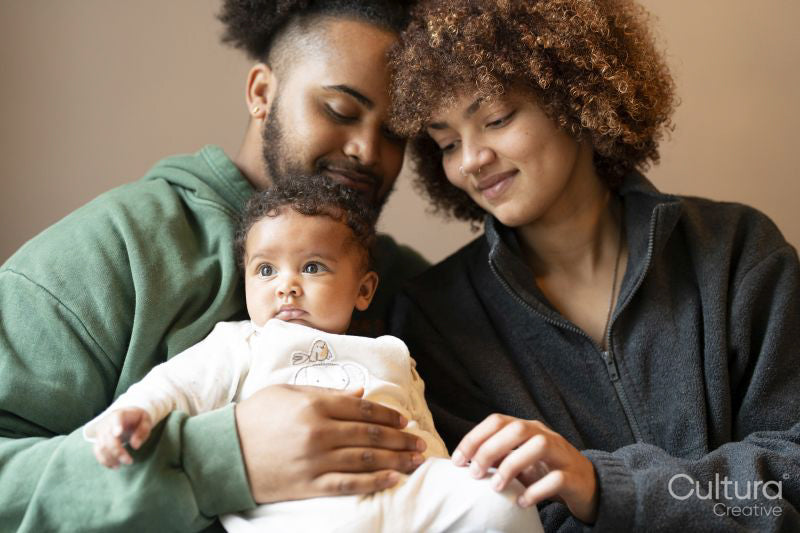 Parents sitting with baby daughter at home