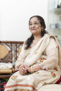 Portrait of cheerful senior woman sitting in living room