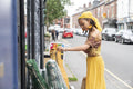 Young woman looking at outdoor display in city