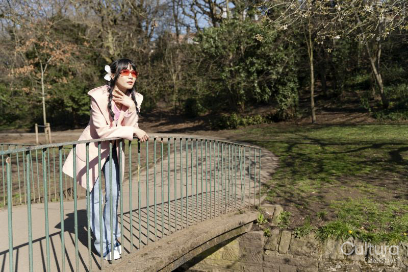 Young woman standing on bridge in park