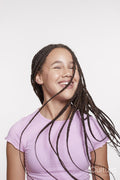 Studio portrait of smiling girl with long braided hair
