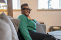 Smiling senior woman relaxing on sofa at home