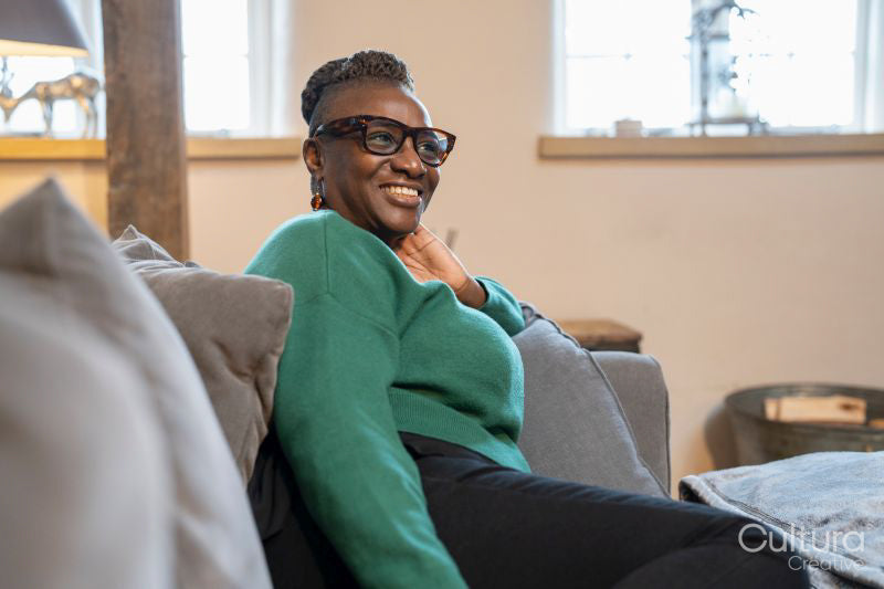 Smiling senior woman relaxing on sofa at home