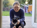 Portrait of girl with Down Syndrome sitting on patio with cat