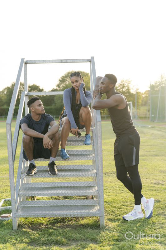 Group of athletes sitting on steps at stadium