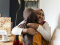 Female friends embracing at home
