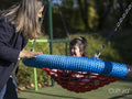 Mother and daughter with Down syndrome using swing on playground