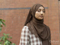 Portrait of woman wearing hijab in backyard