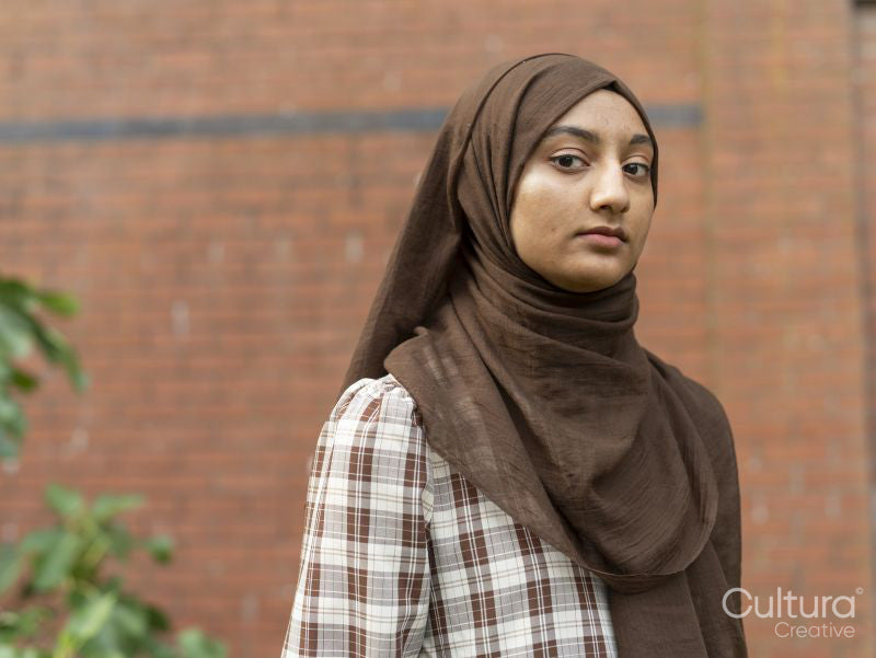 Portrait of woman wearing hijab in backyard