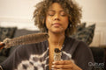 Woman holding smoldering white sage and feather