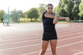 Female athlete stretching arms before training