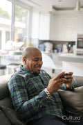 Mature man using smartphone at home