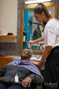 Smiling senior woman getting hair washed in hair salon