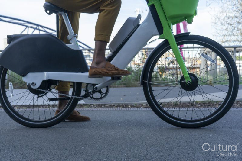 Man riding rental bicycle