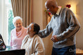 Senior people singing at piano in nursing home