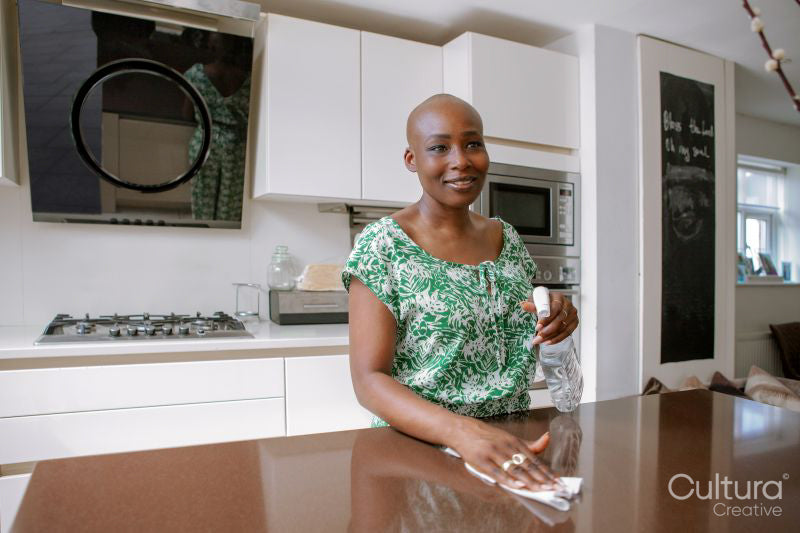 Woman cleaning kitchen counter