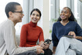 Coworkers having meeting in office lobby