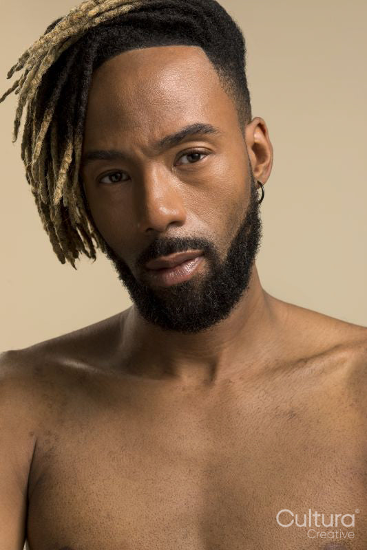 Studio portrait of young man with dreadlocks