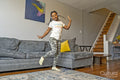Girl with headphones dancing in living room
