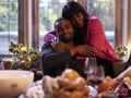 Mother hugging son at Thanksgiving table
