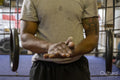 Mature man rubbing hands in gym, midsection