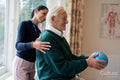 Senior man exercising with physical therapist