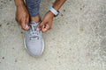 Woman tying shoelace
