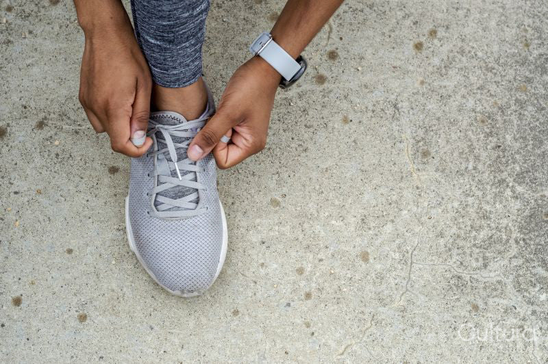 Woman tying shoelace