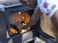 Man starting barbecue grill