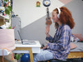 Girl using laptop with headphones at home