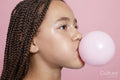 Close-up of girl blowing bubble gum