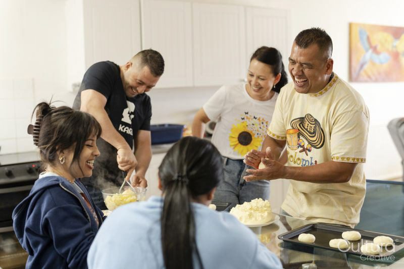 Members of family preparing food in kitchen