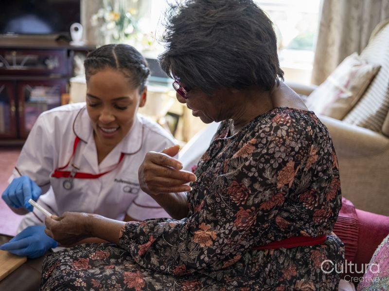 Nurse taking care of elderly woman