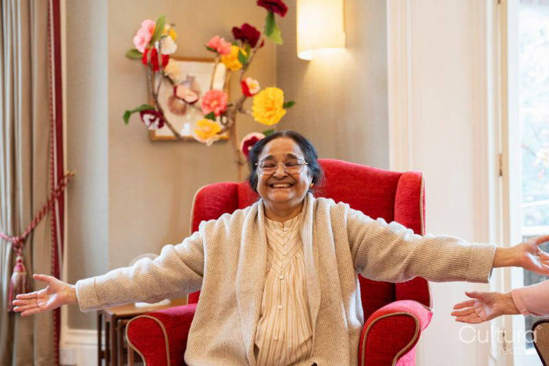 Smiling senior woman exercising in nursing home