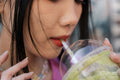 Close-up of young woman drinking sweet drink