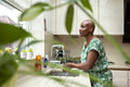 Woman washing hands in kitchen sink
