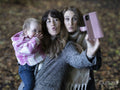 Couple with baby taking selfie in park