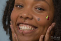 Portrait of young woman wearing star stickers on face
